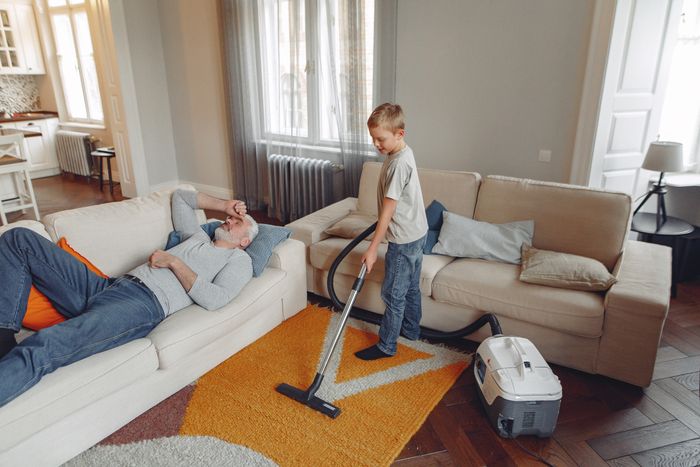 Vacuuming a rug in a living room, representing everyday dirt and grime