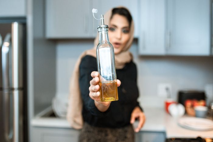 A bottle of cooking oil, representing grease and oil stains