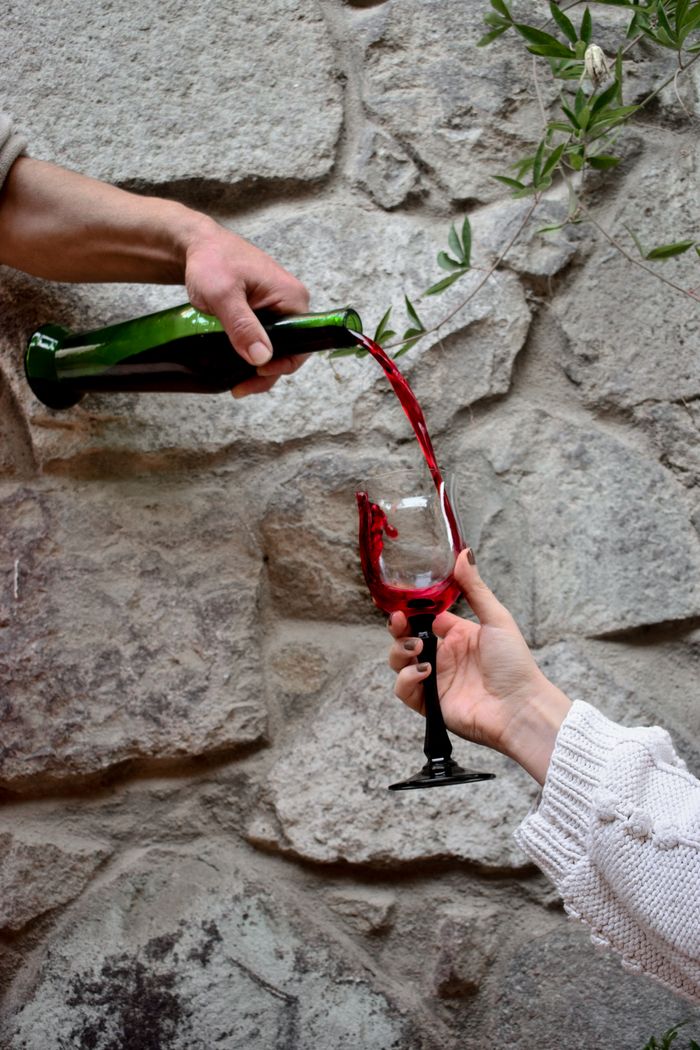 Red wine being poured into a glass, representing red wine stains