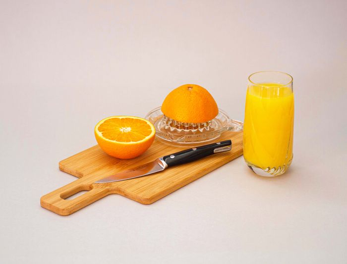 A glass of orange juice, representing soft drink and juice stains