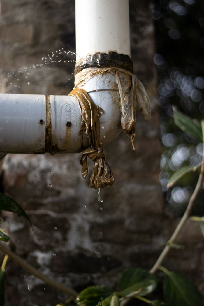 A leaking pipe, representing water marks